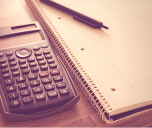 Calculator with a pen and notepad